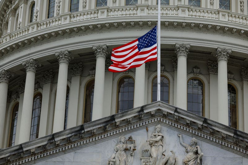The U.S. flag above atop the U.S. Capitol flies at half-staff. 