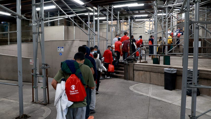 Migrants are pictured entering a shelter in Manhattan.