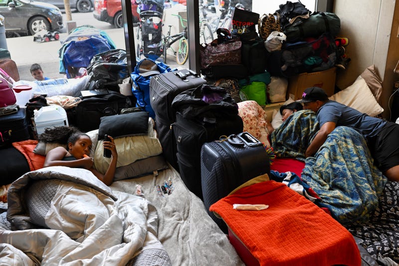 migrants laying in Chicago police station