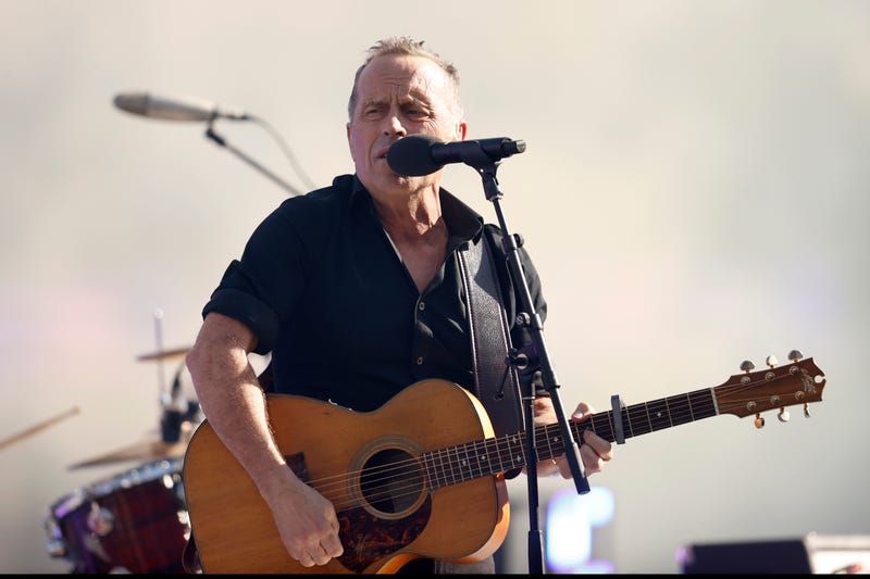 Mark Seymour playing guitar on stage
