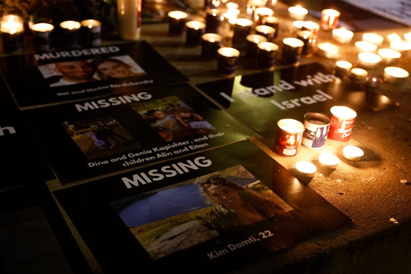 Images of the missing are displayed during a candlelit vigil for Israel at Downing Street on October 9, 2023