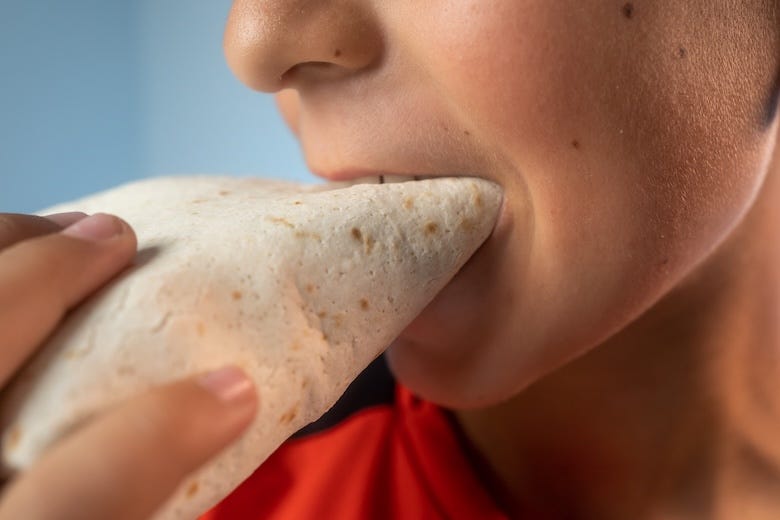 Boy eating a tortilla