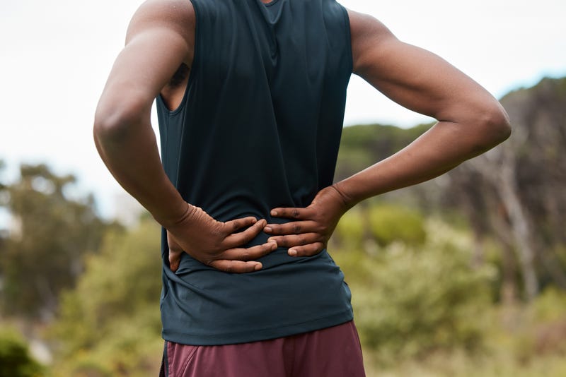 A person with back pain after hiking.