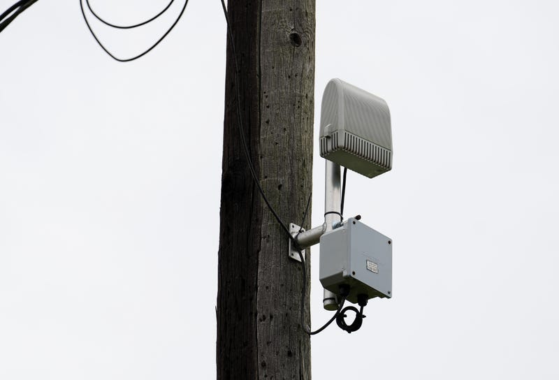 A ShotSpotter device is seen on a pole