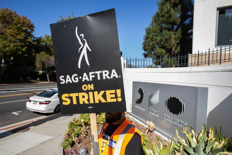 A worker holding a picket sign stands in front of the Sony Pictures Studio during a SAG-AFTRA picket line on October 11, 2023 in Culver City, California.