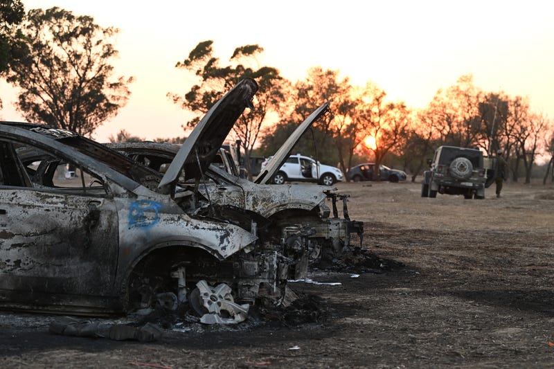 Burnt out cars at the scene as Israeli soldiers searched for ID and belongings among the cars and tents at the Supernova Music Festival site on October 12, 2023 in Kibbutz Re’im Israel.
