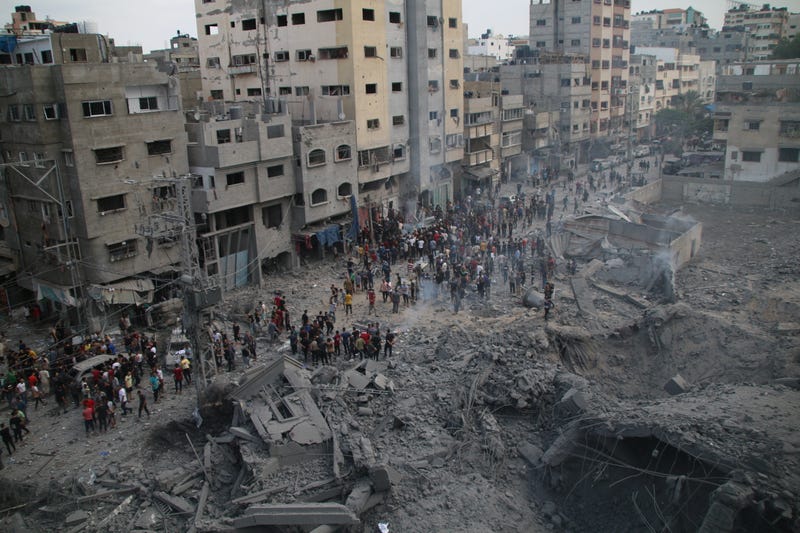 Palestinian citizens inspect damage from Israeli air strikes