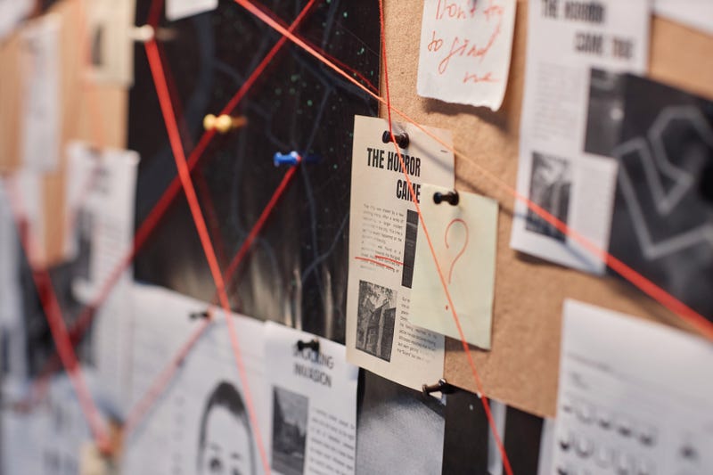 evidence board with red thread connecting pictures