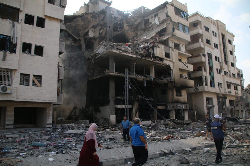 Palestinian citizens inspect damage to their homes from Israeli airstrikes on Oct. 10, 2023, in Gaza City.