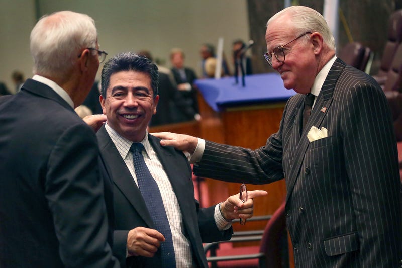 (From left to right) Former aldermen Richard Mell, Danny Solis and Ed Burke stand in the Chicago City Council on May 18, 2023.