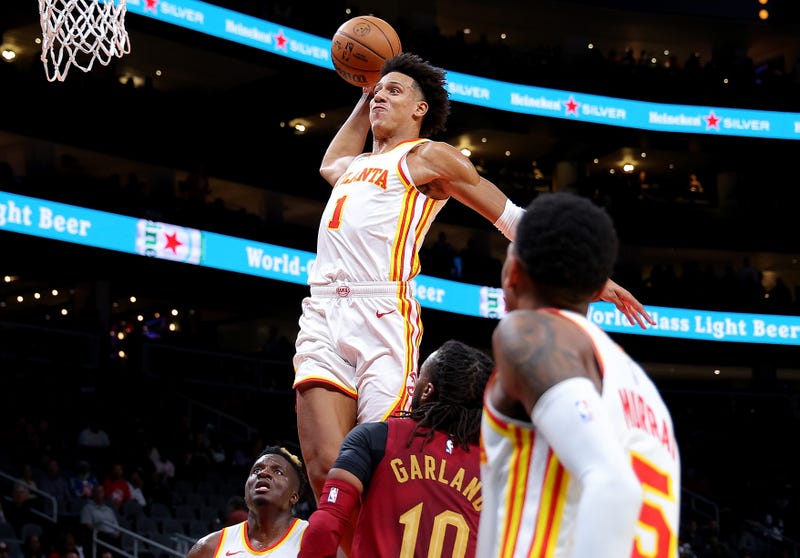 Jalen Johnson #1 of the Atlanta Hawks dunks past Darius Garland #10 of the Cleveland Cavaliers