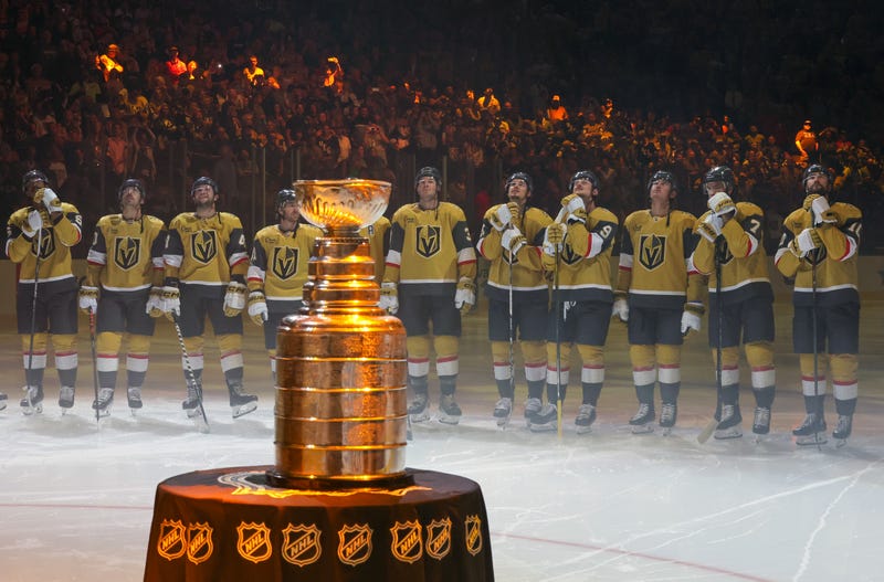 The Stanley Cup is displayed as (L-R) Keegan Kolesar #55, Chandler Stephenson #20 Paul Cotter #43, Jonathan Marchessault #81, Brayden McNabb #3, Brett Howden #21, Jack Eichel #9, Zach Whitecloud #2, Alex Pietrangelo #7 and Nicolas Roy #10 of the Vegas Golden Knights watch the 2023 Stanley Cup championship banner being raised during a ceremony before the team's home opener against the Seattle Kraken at T-Mobile Arena on October 10, 2023 in Las Vegas, Nevada. The Golden Knights defeated the Kraken 4-1.