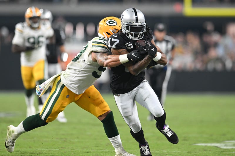 Davante Adams #17 of the Las Vegas Raiders is tackled by Isaiah McDuffie #58 of the Green Bay Packers in the fourth quarter at Allegiant Stadium on October 09, 2023 in Las Vegas, Nevada
