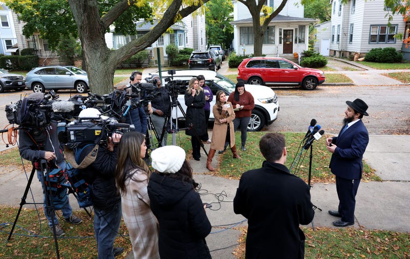Rabbi reacts talks with reporters