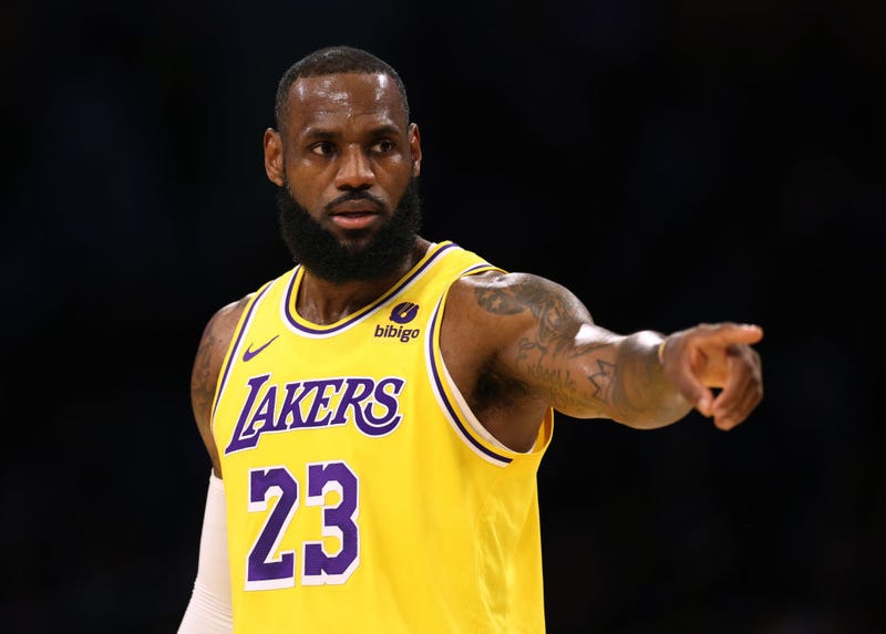  LeBron James #23 of the Los Angeles Lakers directs the defense during a 129-125 loss to the Golden State Warriors in a preseason game at Crypto.com Arena on October 13, 2023 in Los Angeles, California. 