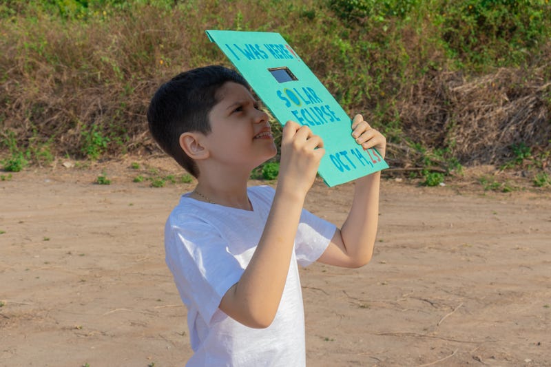 child watching eclipse