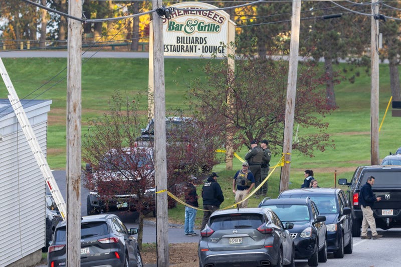 Law enforcement officials investigate outside the Schemengees Bar and Grille on October 26, 2023 in Lewiston, Maine.