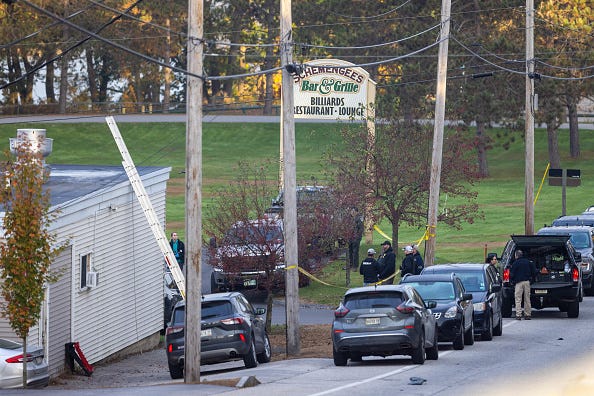 Law enforcement officials investigate outside the Schemengees Bar and Grille on October 26, 2023 in Lewiston, Maine.