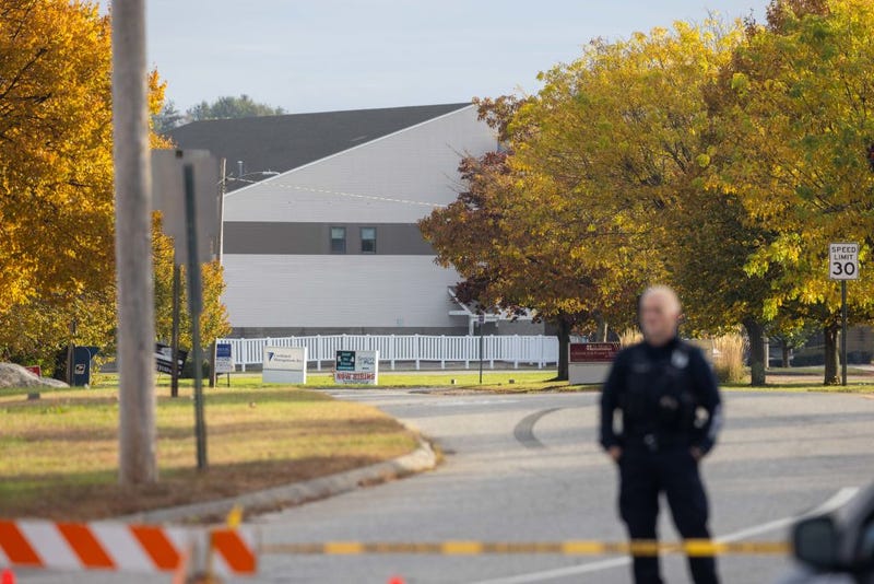 A police officer blocks access to the road to Sparetime Recreation on October 26, 2023 in Lewiston, Maine.