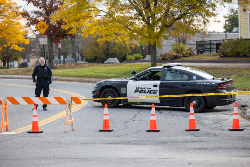 A police officer blocks access to the road to Sparetime Recreation on October 26, 2023 in Lewiston, Maine. 