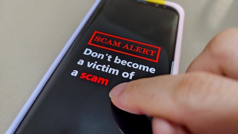 A mobile phone showing the message Don't Become A Victim Of A Scam