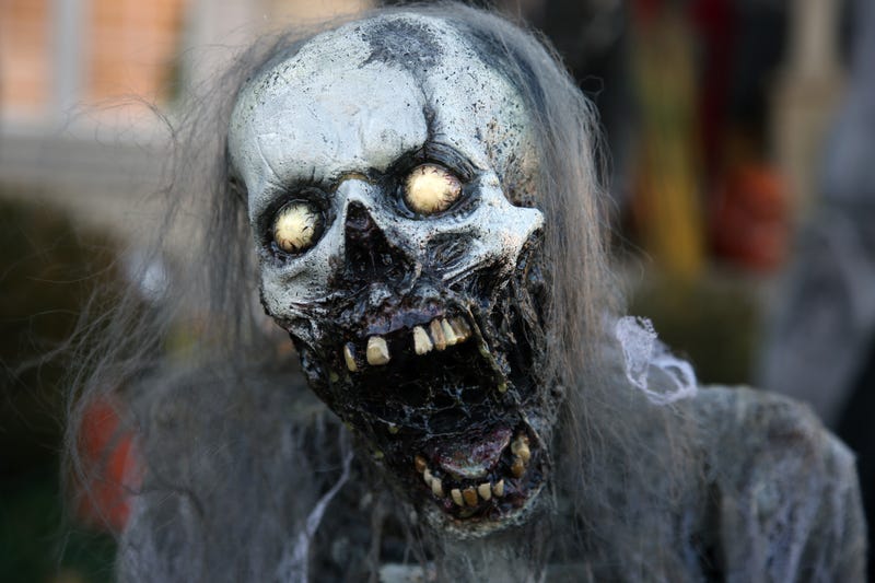 A spook outside of a Halloween attraction