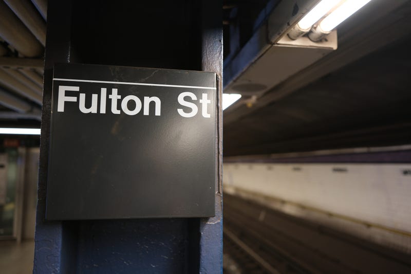 A woman was pushed onto subway tracks by her boyfriend on Saturday morning at the Fulton Street subway station, and an arriving train amputated her feet.