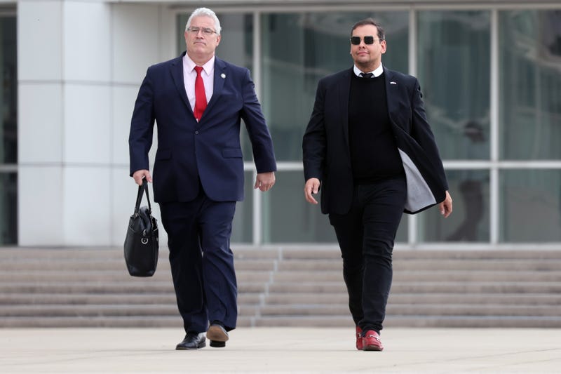 Then-Rep. George Santos (R-NY) walks out of a federal courthouse in Long Island with his lawyer Joe Murray on Oct. 27, 2023 in Central Islip, New York