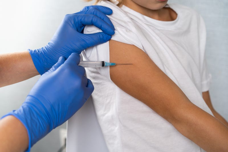 vaccination of children, a little boy at a doctor's appointment, an injection in the arm, children's medicine, an injection in the arm.
