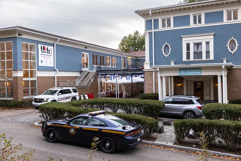 A Cornell University campus police officer and a state trooper sit parked outside the Center for Jewish Living on Nov. 3, 2023 in Ithaca, New York, after threats were made to Jewish students