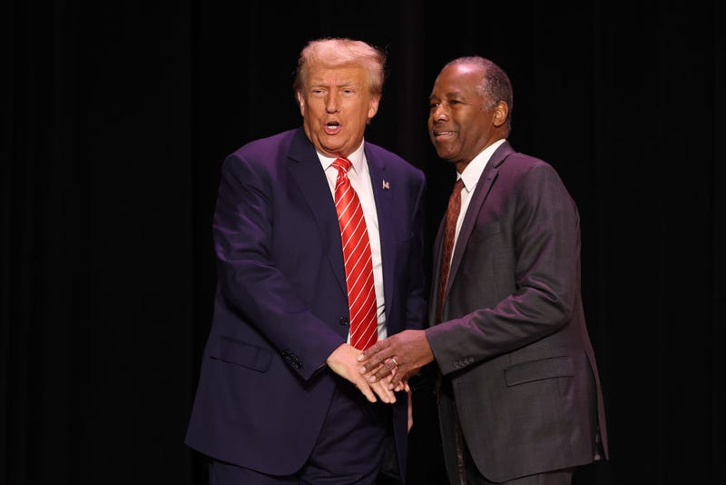 Republican presidential candidate former U.S. President Donald Trump greets former HUD Secretary Ben Carson during a campaign event where he received Carson's endorsement on October 29, 2023 in Sioux City, Iowa. On Saturday, Trump joined other Republican presidential candidates when he addressed Republican Jewish Coalition’s annual conference where his one-time vice president, Mike Pence, announced he was suspending his campaign. (Photo by Scott Olson/Getty Images)