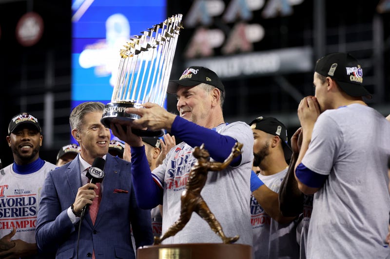 Manager Bruce Bochy of the Texas Rangers hoists trophy