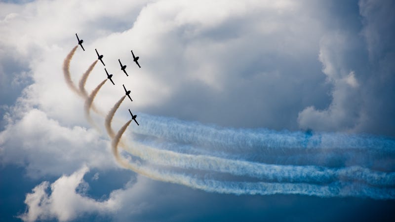 Seven airplanes fly in formation.