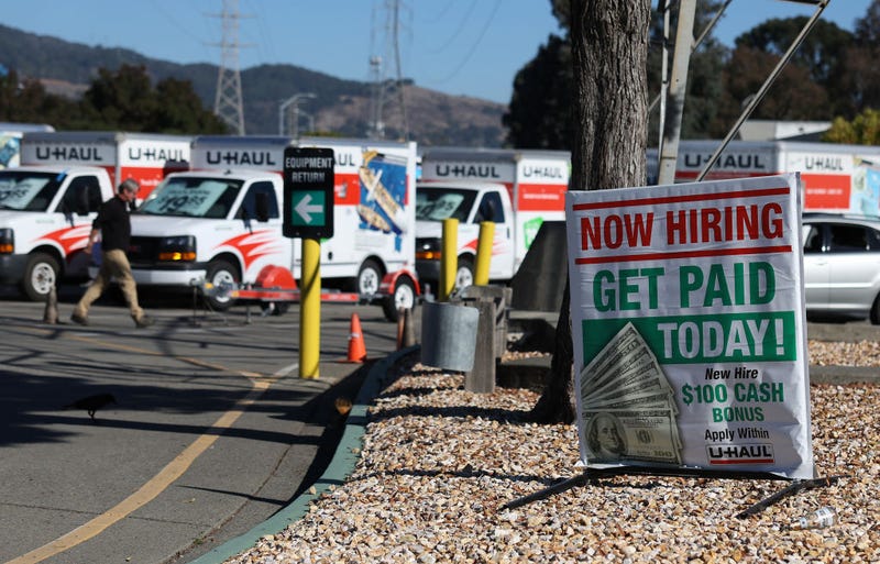A now hiring sign is posted in front of a U-Haul rental center on November 03, 2023 in San Rafael, California.