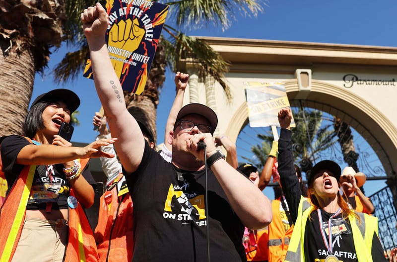  SAG-AFTRA National Executive Director and chief negotiator Duncan Crabtree-Ireland (C) raises his fist while speaking at the conclusion of picketing outside Paramount Studios on day 113 of their strike against the Hollywood studios on November 3, 2023 in Los Angeles, California.