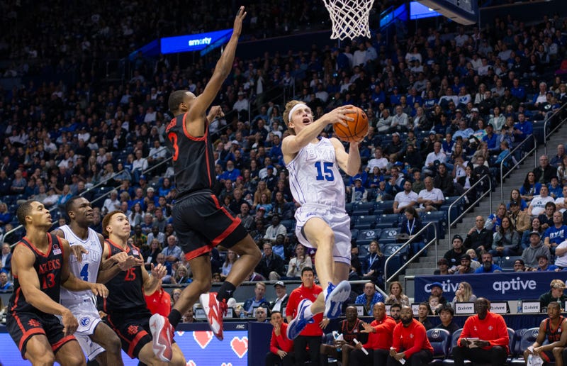 BYU Cougars' player Richi Saunders leaps towards the basket to attempt a shot against the San Diego State Aztecs.
