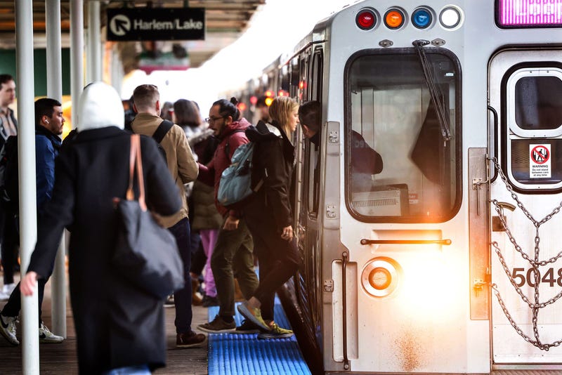 CTA commuters board a Pink Line train
