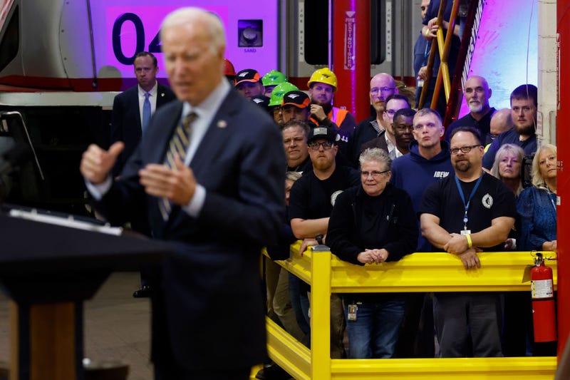 Union members and Amtrak workers listen as U.S. President Joe Biden announces more than $16 billion in new funding for rail projects on the Northeast Corridor while surrounded by trains inside the Amtrak Bear Heavy Maintenance Facility on November 06, 2023 in Bear, Delaware. Last week Biden threatened to veto legislation proposed by House Republicans for FY2024 that would cut Amtrak funding by 64% below the 2023 enacted level. (Photo by Chip Somodevilla/Getty Images)