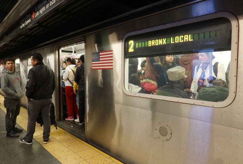 Two people wait on a platform to board a 2 train on Nov. 6, 2023, in New York City.