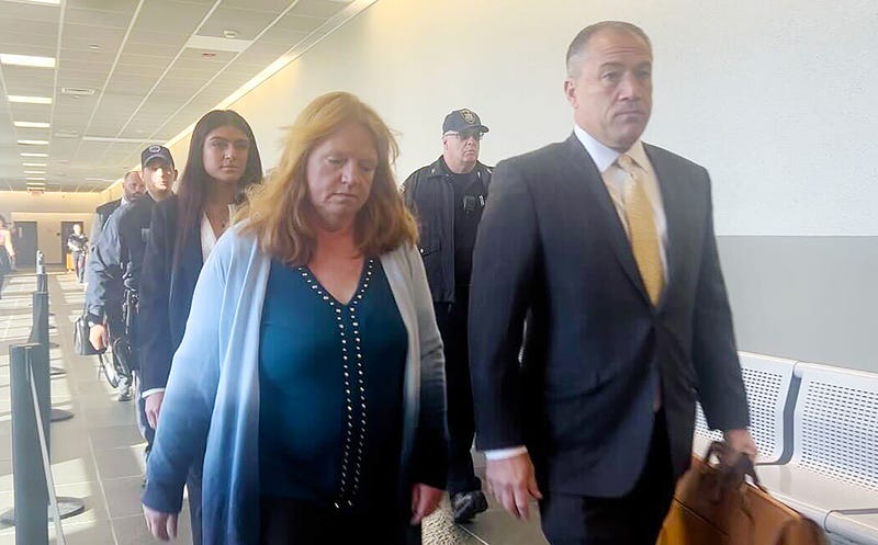 Asa Ellerup, wife of Gilgo Beach suspect Rex Heuermann, walks into the courtroom in Riverhead with her lawyer, Bob Macedonio, on Nov. 15, 2023