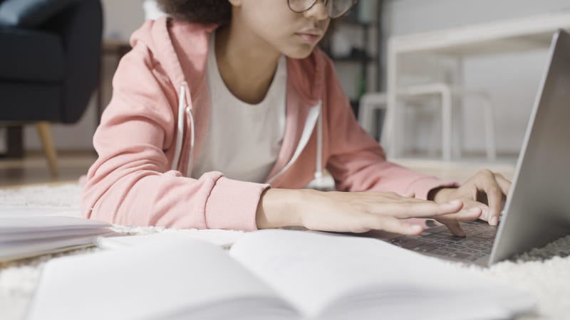 girl on floor working on laptop