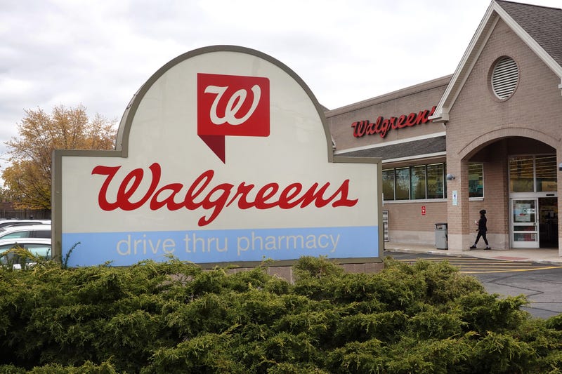 sign sits in front of a Walgreens store