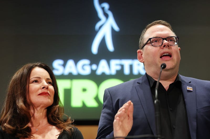 SAG-AFTRA President Fran Drescher (L) looks on as SAG-AFTRA National Executive Director Duncan Crabtree-Ireland speaks at a press conference discussing their strike-ending deal with the Hollywood studios on November 10, 2023 in Los Angeles, California.