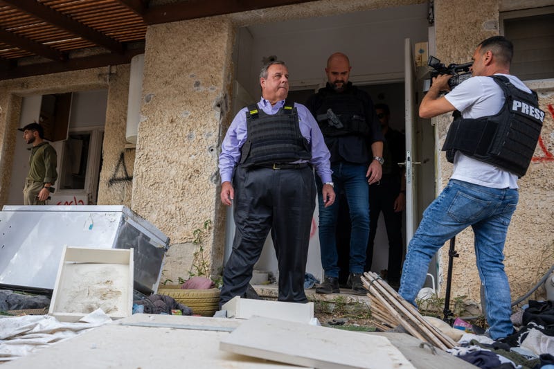Chris Christie (C) walks out of a home that was targeted by Hamas on Oct. 7 near Gaza on Nov. 12, 2023 in Kfar Aza, Israel