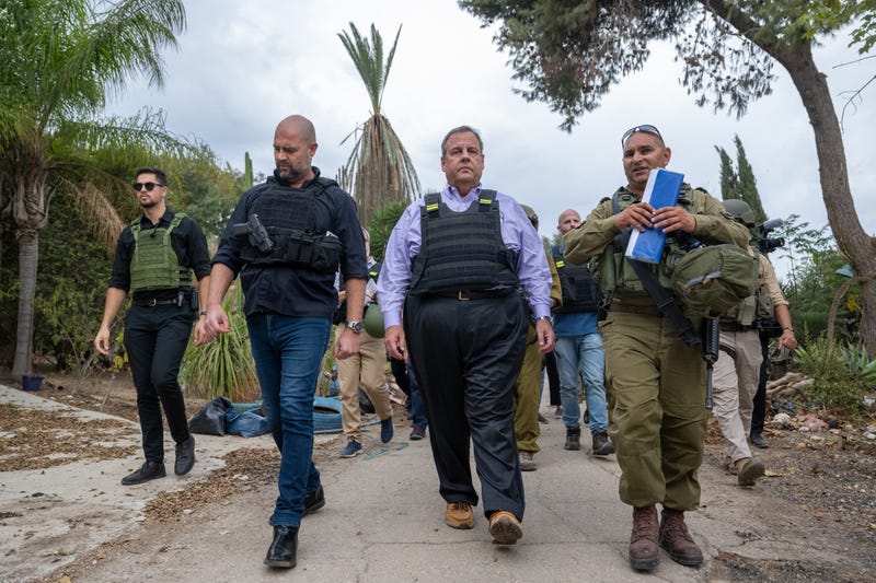 Chris Christie (C) led by IDF Spokesperson Maj. Liad Diamond (R), and Amir Ohana (L), speaker of the Knesset, visits Kibbutz Kfar Aza
