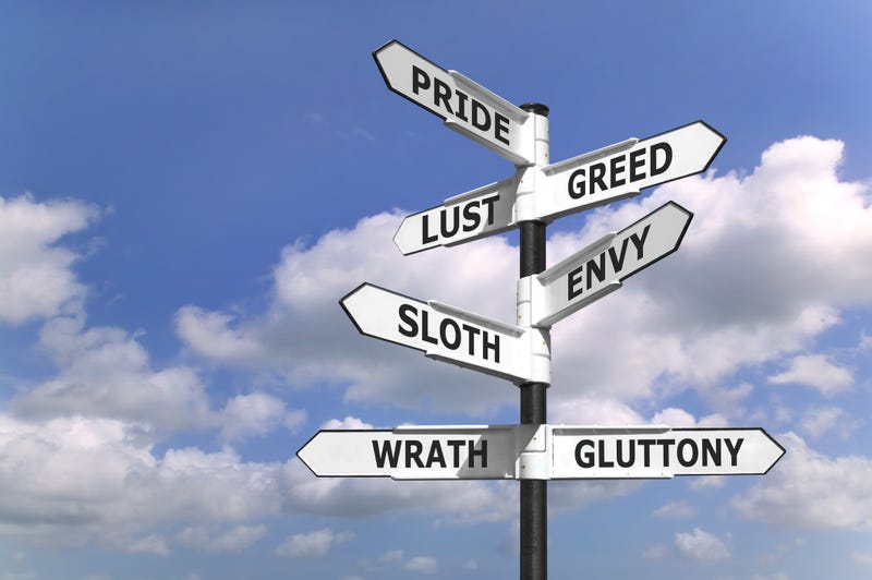 signpost with the seven deadly sins upon the arrows.