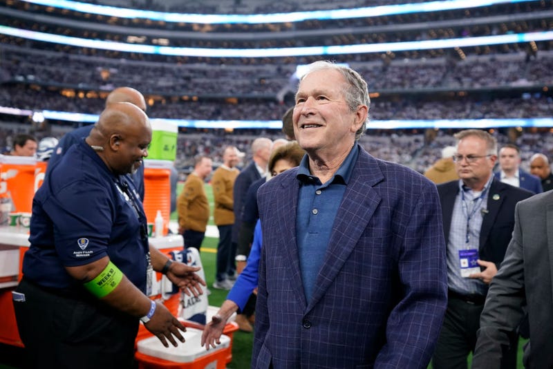 ARLINGTON, TEXAS - NOVEMBER 12: Former president George W. Bush walks the field after the coin toss before the game between the New York Giants and Dallas Cowboys at AT&T Stadium on November 12, 2023 in Arlington, Texas. (Photo by Sam Hodde/Getty Images)