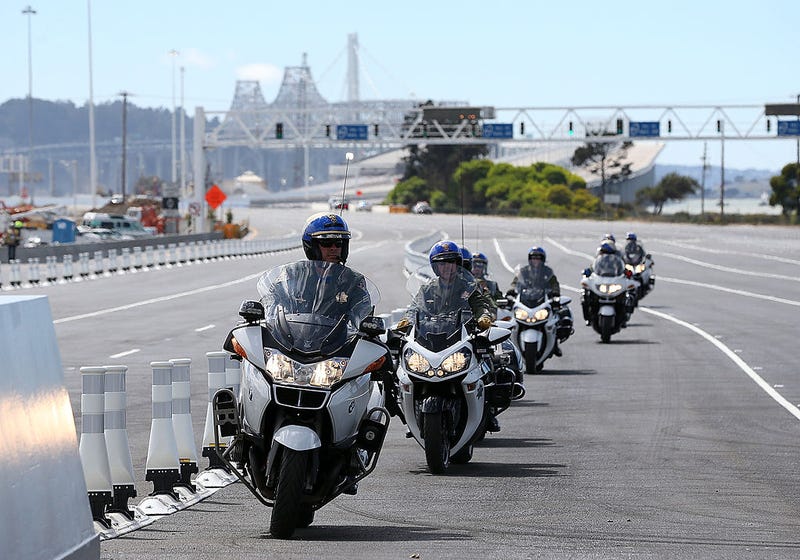California Highway Patrol officers ride in formation by the toll plaza before a chain-cutting ceremony to officially open the new eastern span of the San Francisco Oakland Bay Bridge on August 30, 2013 in Oakland, California. After nearly 12 years of construction and an estimated price tag of $6.4 billion, the new eastern span of the Bay Bridge will open to traffic a day ahead of schedule. The bridge will be the world's tallest self-anchored suspension tower once completed. (Photo by Justin Sullivan/Getty Images)