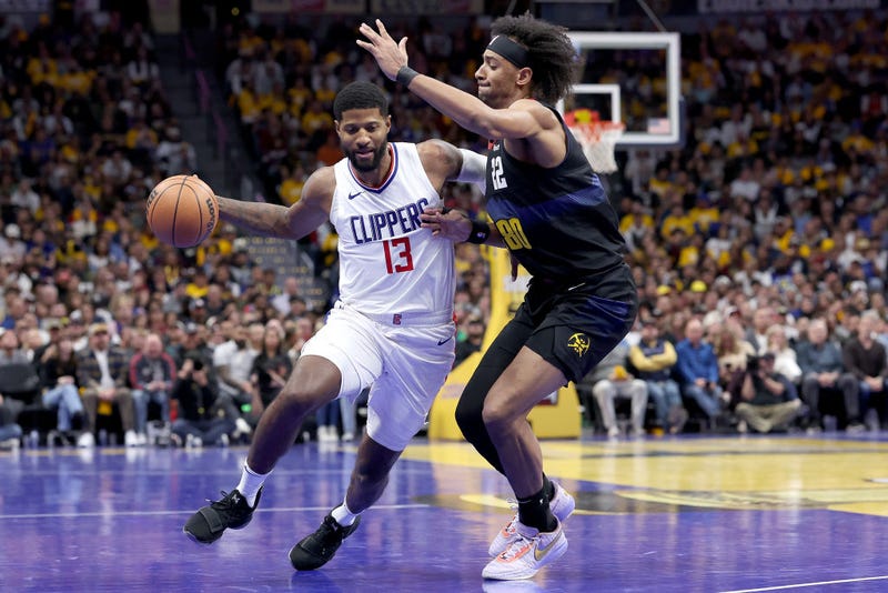 Paul George #13 of the Los Angeles Clippers drives against Zeke Nnaji #22 of the Denver Nuggets in the fourth quarter at Ball Arena on November 14, 2023 in Denver, Colorado.