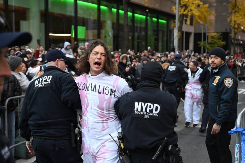 NYPD members take protesters into custody during the Macy's Thanksgiving Day Parade on Nov. 23, 2023